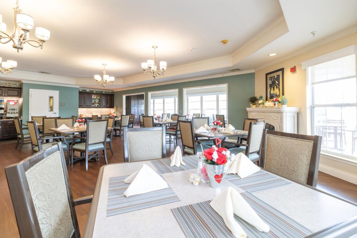 A well-lit dining room with neatly arranged tables and elegant decor.