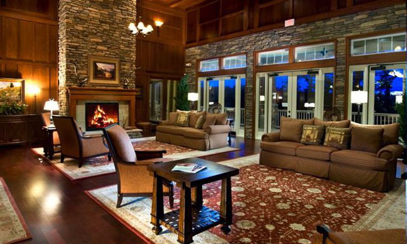 A cozy living room with a fireplace, comfortable seating, and elegant decor.