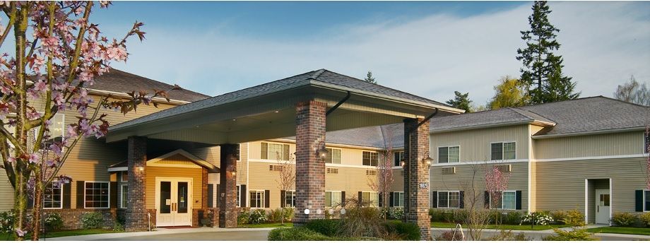 A modern residential building with a covered front entrance.