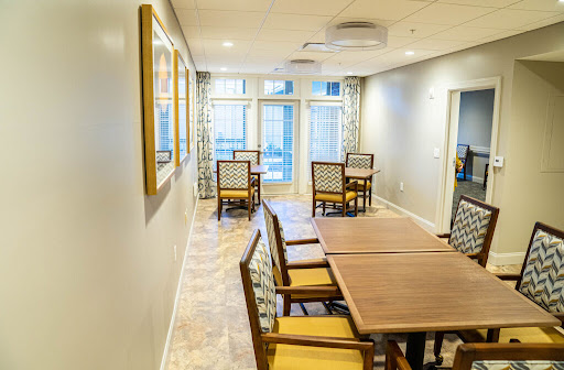 A spacious and inviting dining area with wooden tables and comfortable chairs, perfect for social gatherings.