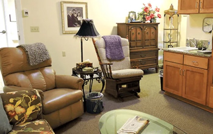 A cozy living room with comfortable seating and decorative elements.