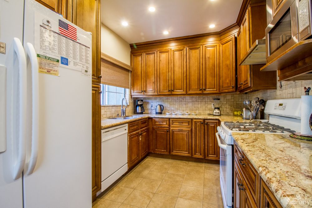 A cozy kitchen with wooden cabinets and modern appliances.