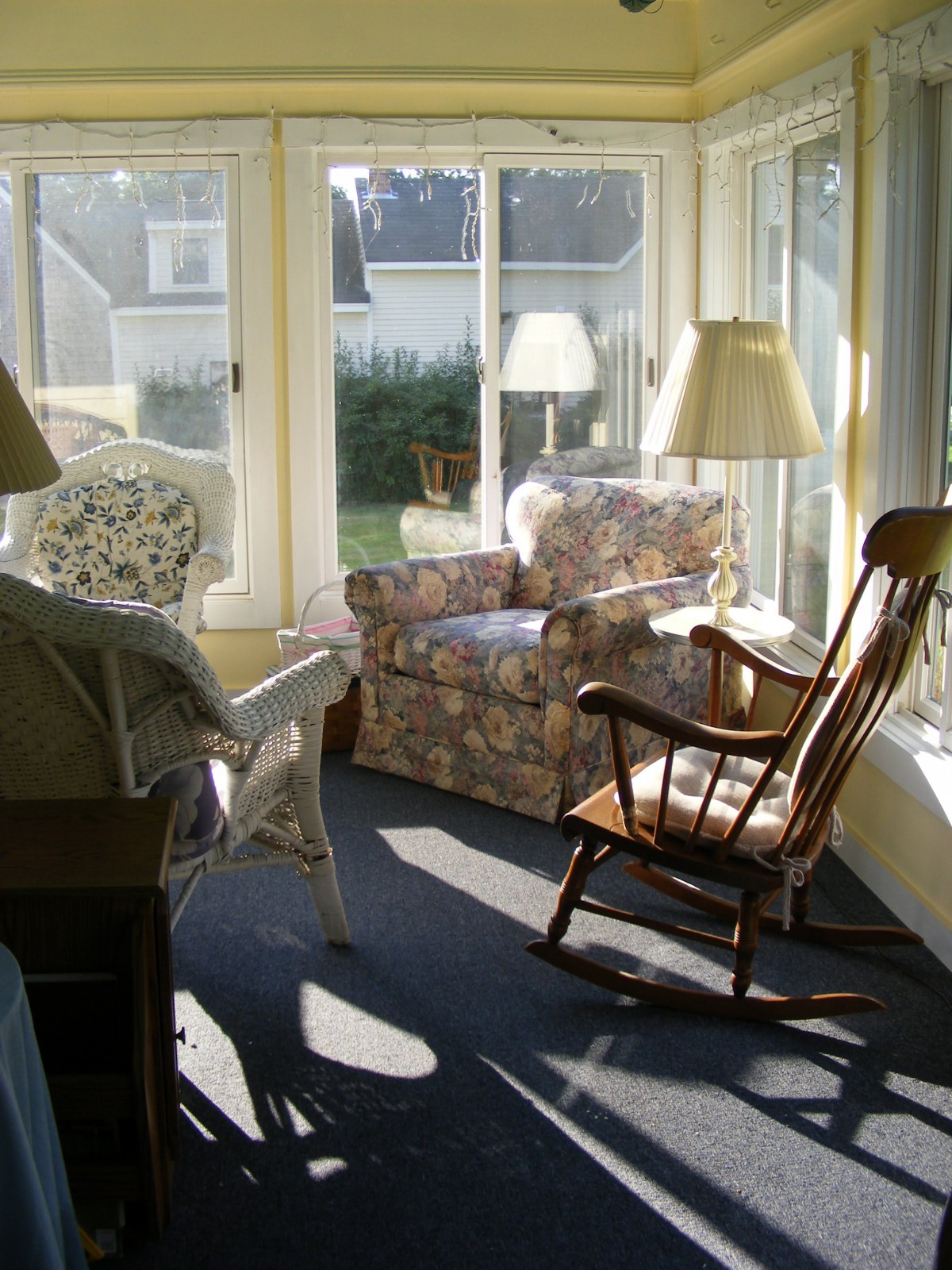 A cozy sunroom with comfortable seating and ample natural light.