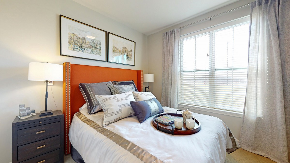 A cozy, well-decorated bedroom with an inviting bed and natural light.