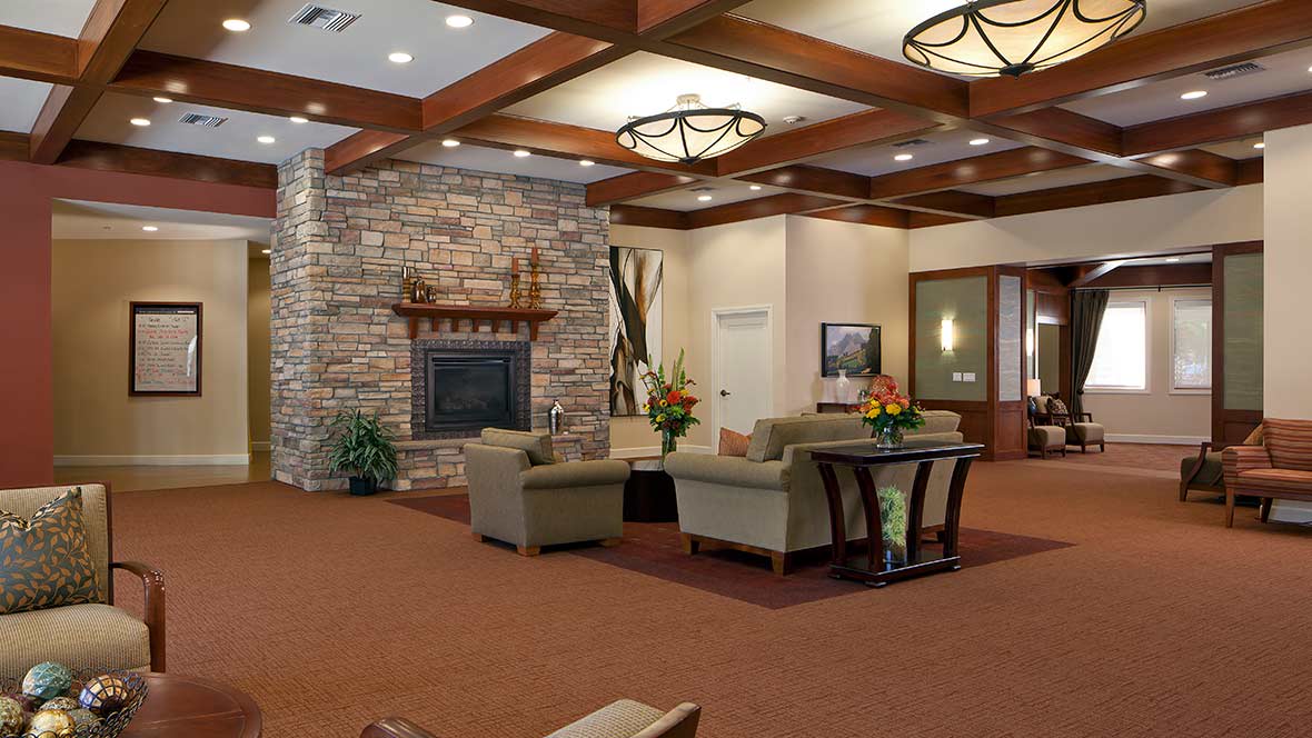 A modern lobby with a cozy seating area and stone fireplace.