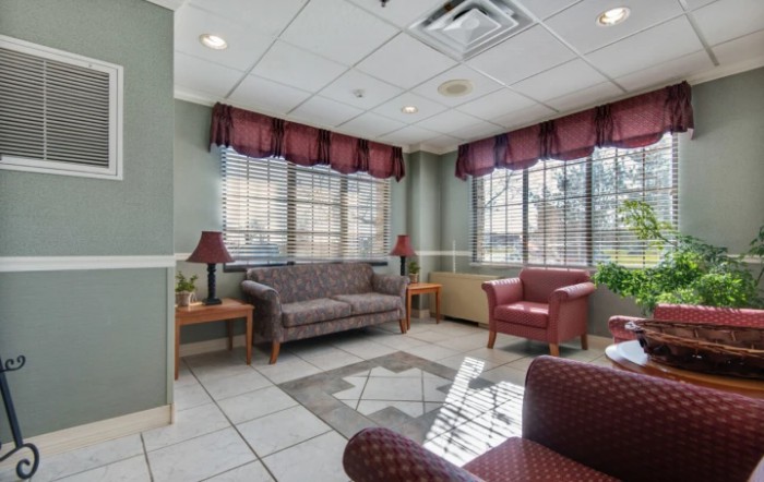 A cozy waiting room with comfortable seating and large windows.