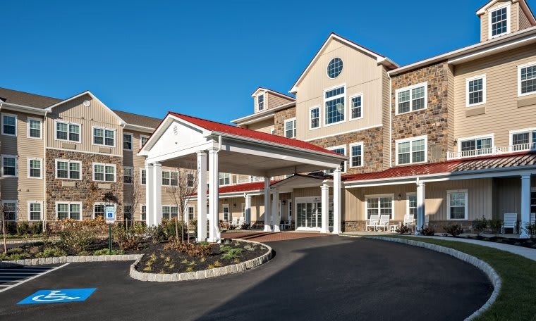 A residential building with a prominent entrance and well-maintained landscaping.