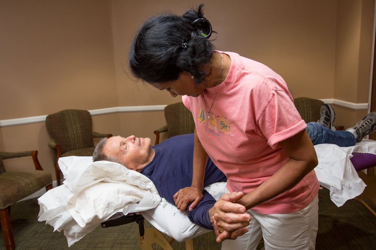 A therapist assists a patient during a physical therapy session.