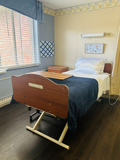 A patient room featuring a hospital bed, equipped with essentials for care.