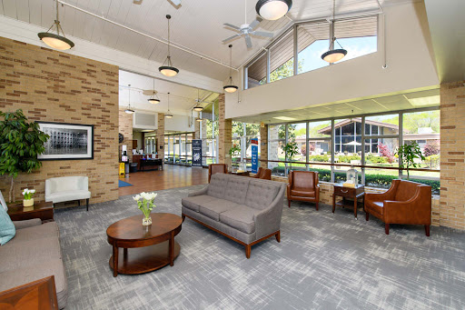 A spacious and inviting lobby featuring comfortable seating, large windows for natural light, and a modern aesthetic.