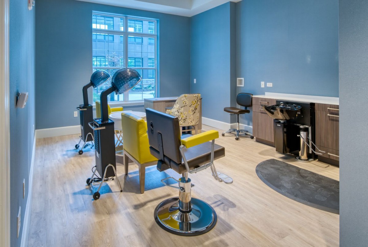 A modern hair salon interior with styling chairs and hairdressing equipment.