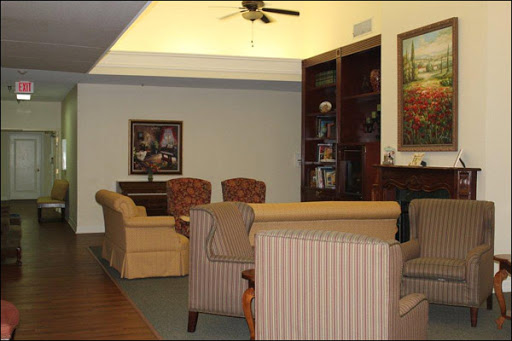 A cozy living room featuring comfortable seating and a bookshelf, perfect for relaxation and socializing.