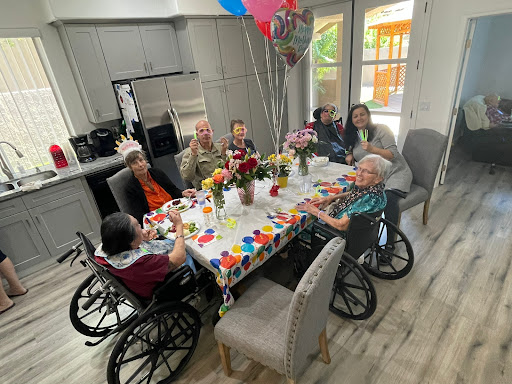 A joyful gathering of seniors celebrating together with festive decorations and balloons.