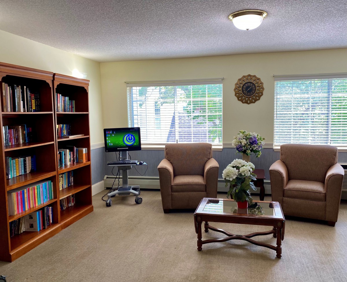 A cozy living room with bookshelves and comfortable seating.