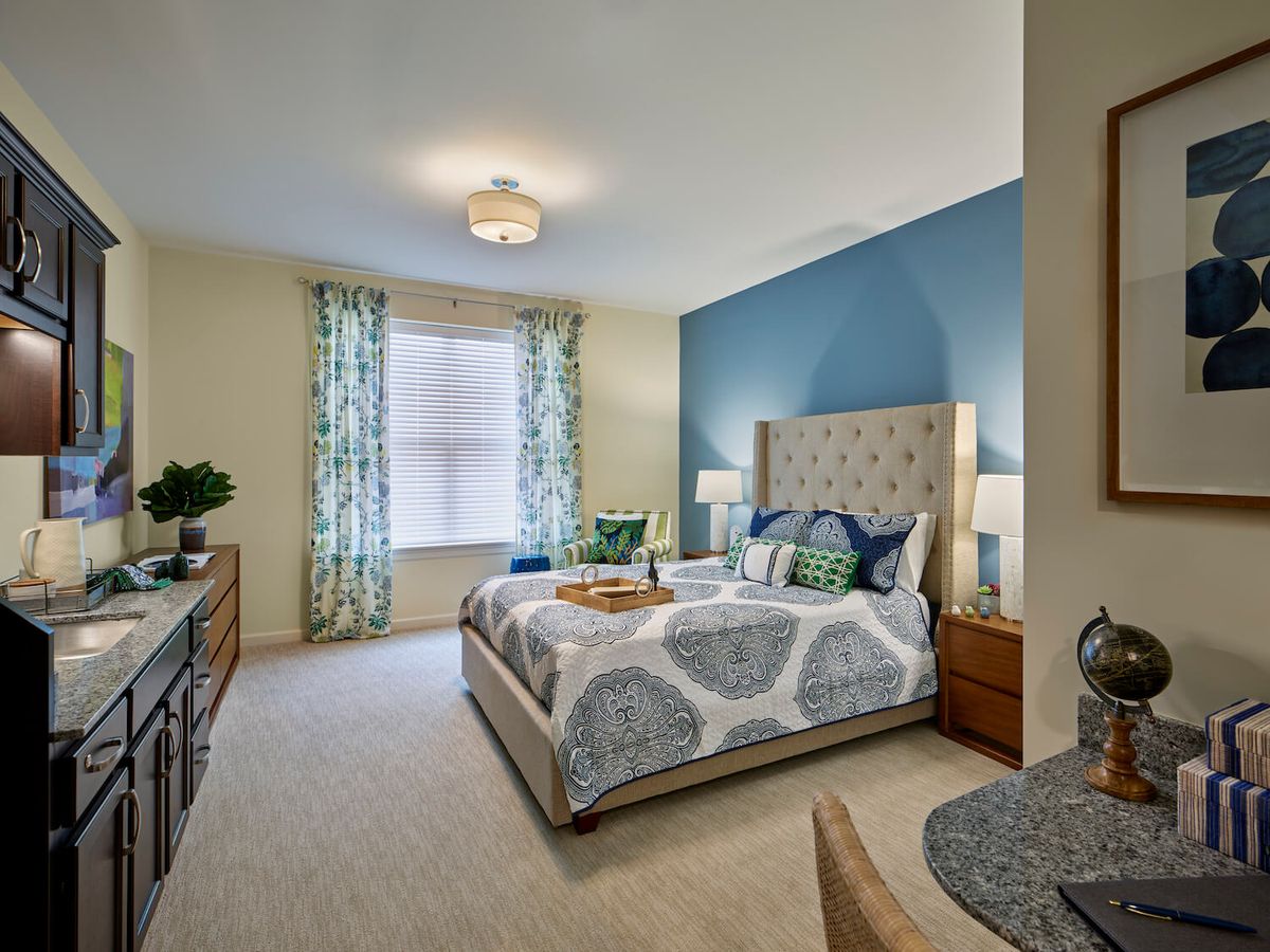 A cozy bedroom with a blue accent wall and elegant decor.