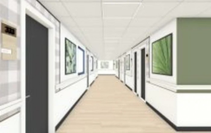 A minimalist hallway adorned with framed artwork on its white walls.