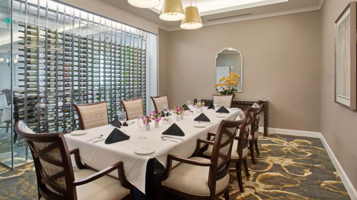 An elegantly set dining room with a formal table arrangement.