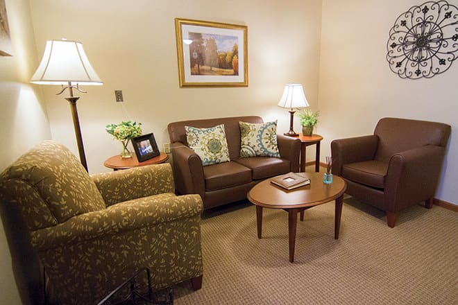 A cozy living room with comfortable seating and warm lighting.