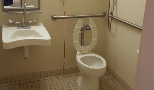 A clean and accessible bathroom featuring a toilet and sink.
