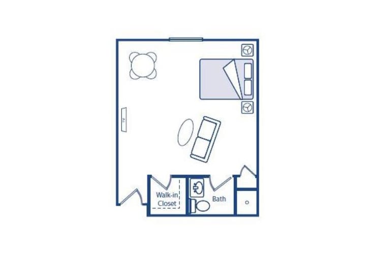 A floor plan of a studio apartment showing the layout with a bed, sofa, table, and bathroom.