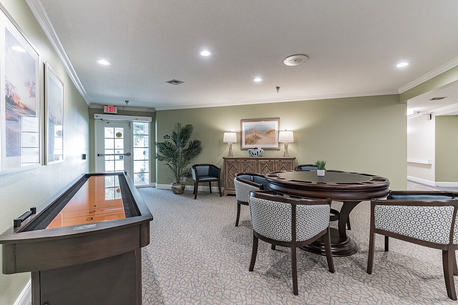 A comfortable lounge area with a round table, chairs, and elegant decor.