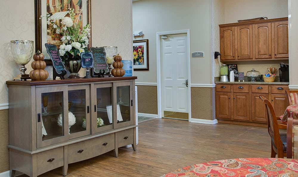 A cozy living room with wooden flooring and decorative furnishings.