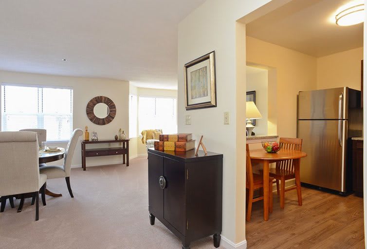 A cozy living space with an open dining area, featuring stylish furniture and decor.