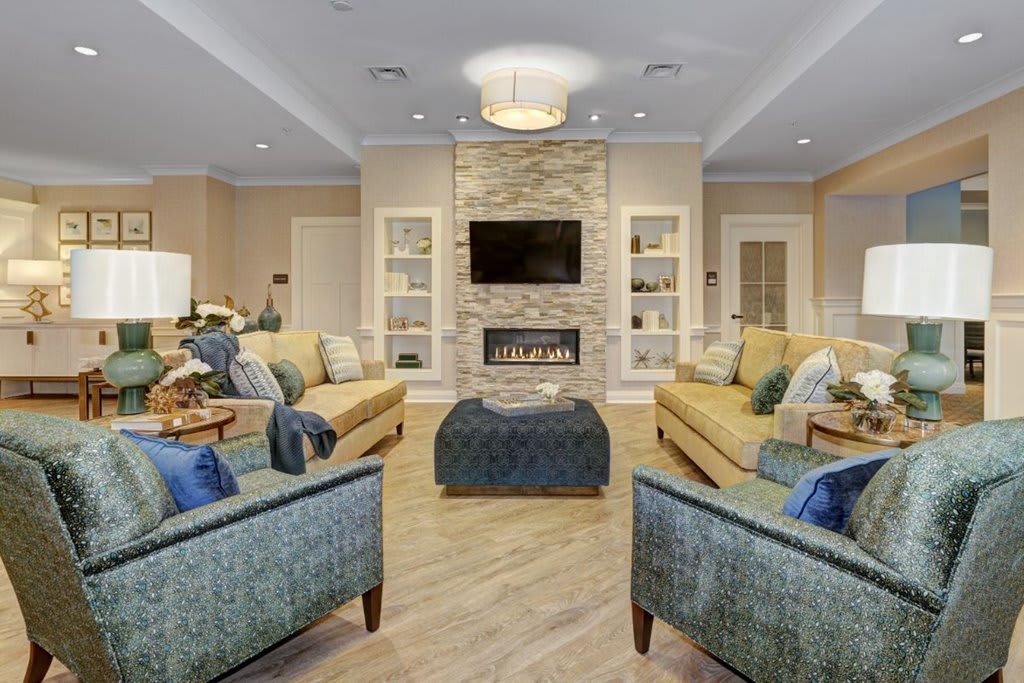 A modern living room with a cozy fireplace and comfortable seating.