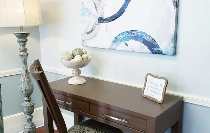 A modern desk setup with abstract artwork and decorative elements.