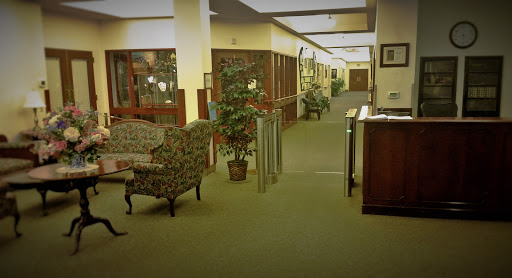 A welcoming lobby area featuring comfortable seating and greenery, designed for relaxation and reception.