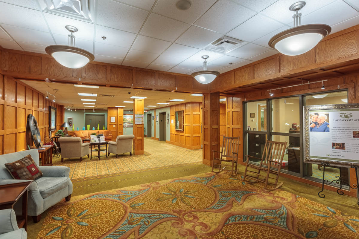 A well-lit lobby area with comfortable seating and decorative carpet.