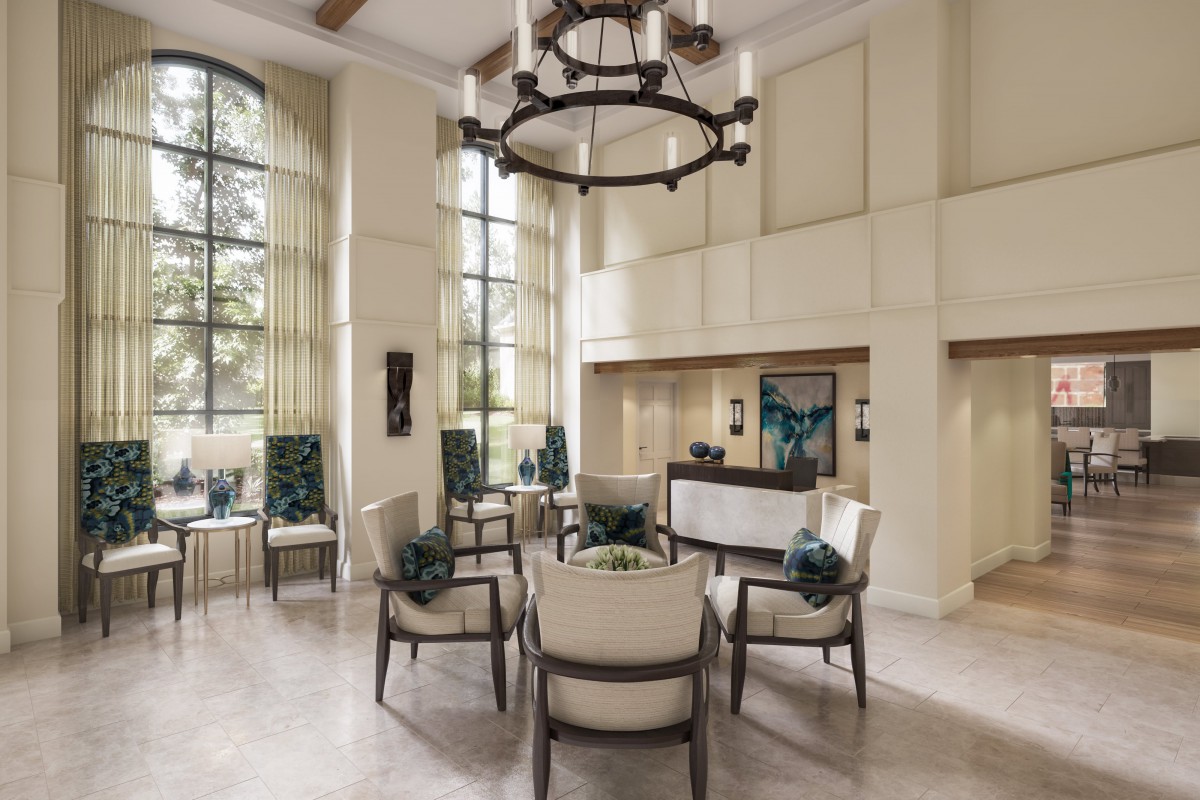 A spacious and elegantly designed lobby with comfortable seating and a large chandelier.