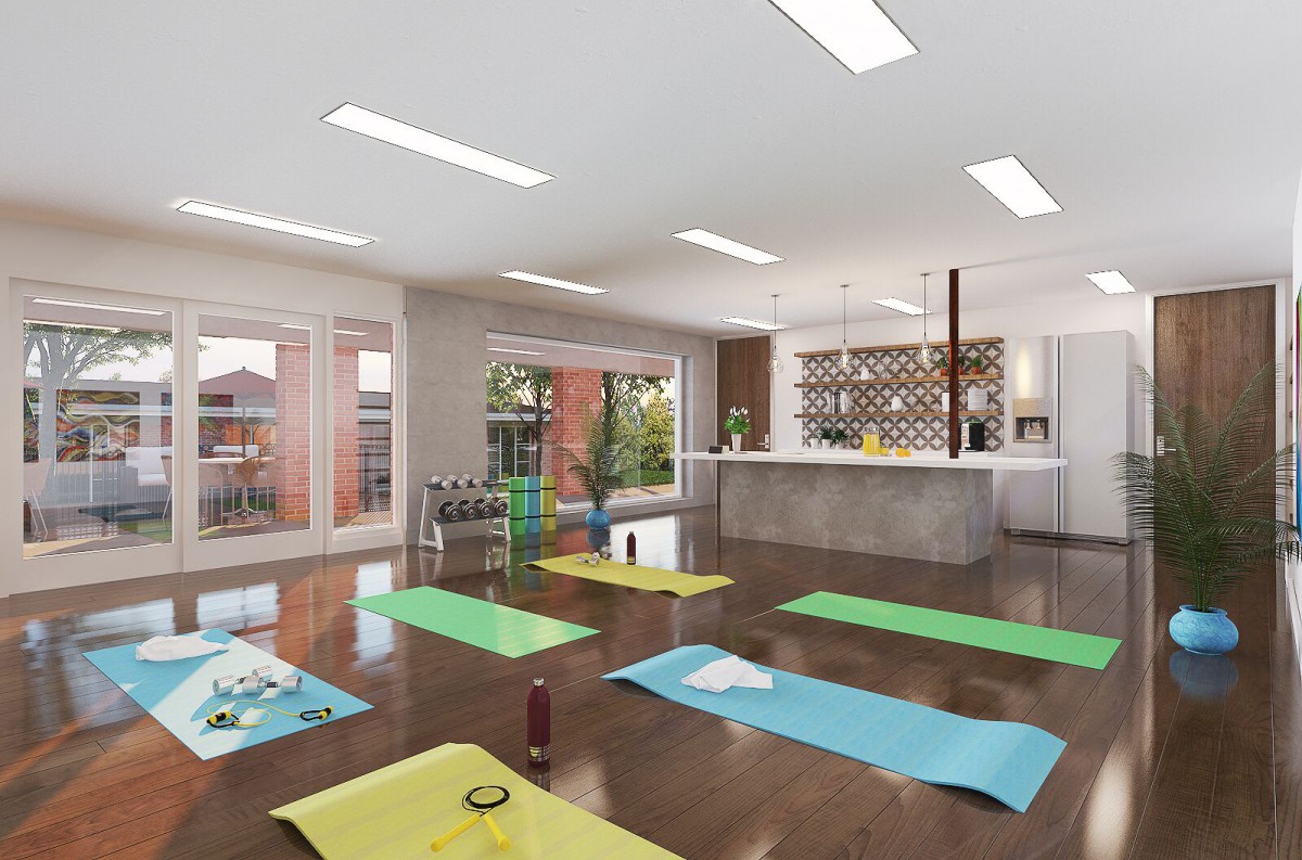 A spacious yoga studio with exercise mats laid out, featuring modern decor and ample natural light.