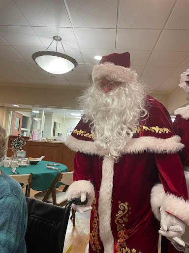 A festive Santa Claus visiting a gathering, spreading holiday cheer.