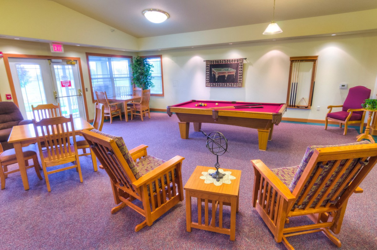 A cozy recreation room featuring a pool table and seating area.