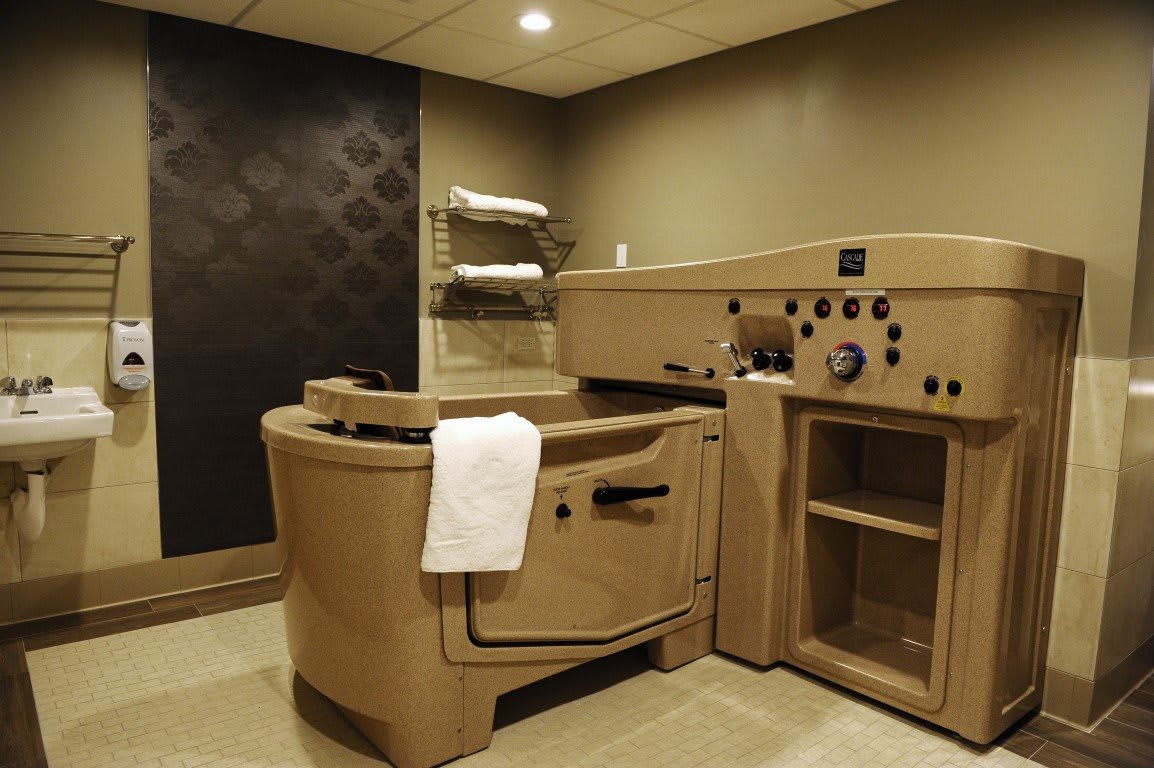 A serene spa room featuring a hydrotherapy tub for relaxation and wellness treatments.