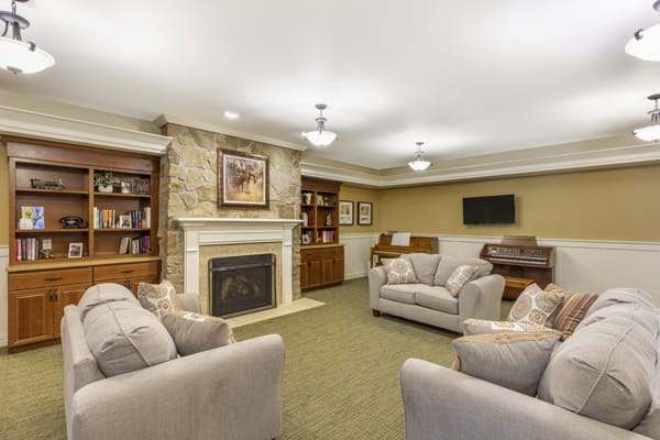 A cozy living room with comfortable seating and a fireplace.