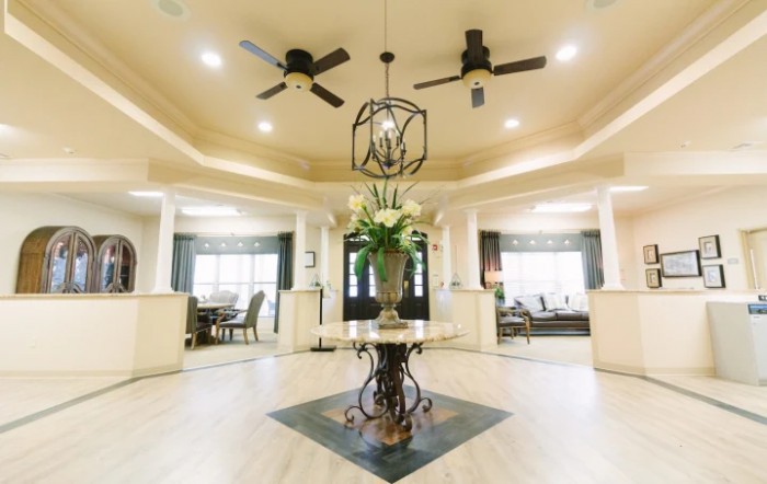 Spacious living area with elegant decor and a central floral arrangement.