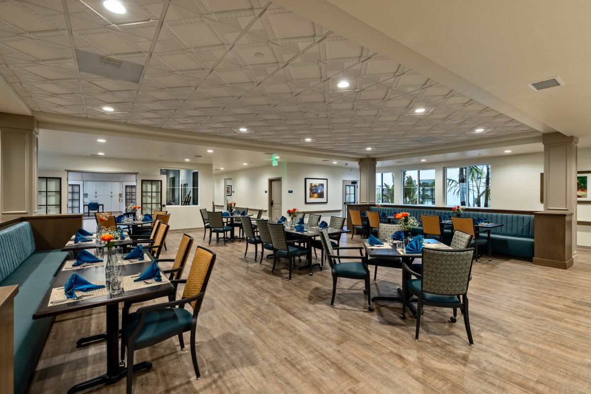 A spacious restaurant dining area with elegantly arranged tables and chairs.