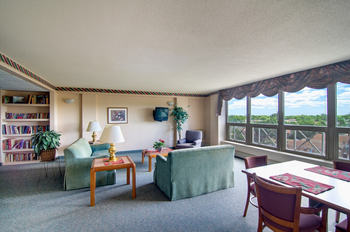 A spacious living room with large windows and comfortable seating.