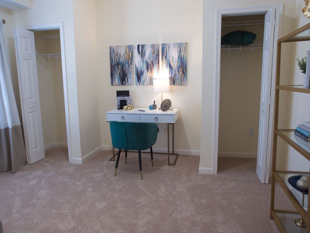 A stylish workspace setup with a desk, chair, and modern artwork in a room.
