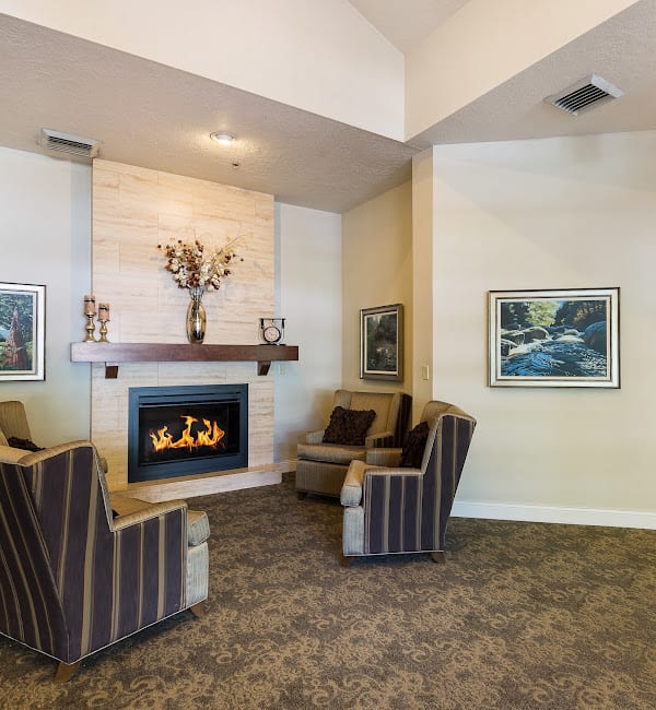 A cozy living room with a fireplace and comfortable seating.