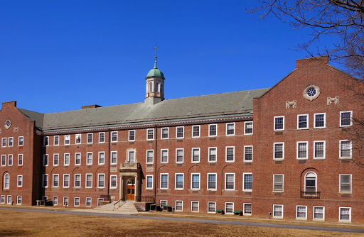 A historic brick building under a clear blue sky.