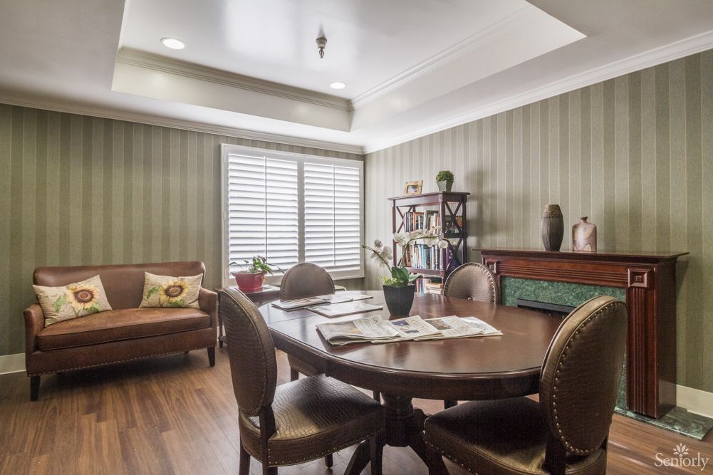 A cozy dining room with a wooden table, chairs, and natural lighting.