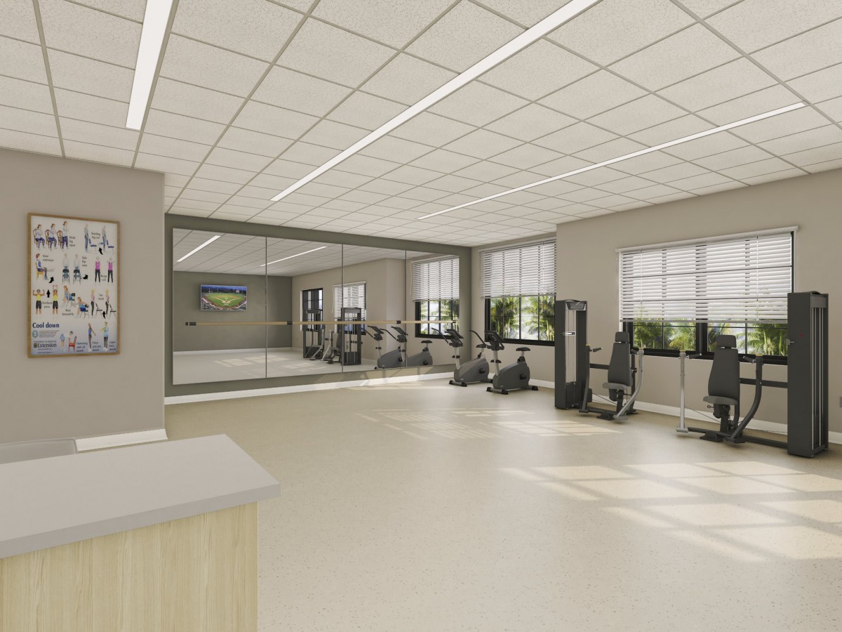A modern, spacious gym with exercise equipment and large windows allowing natural light in.