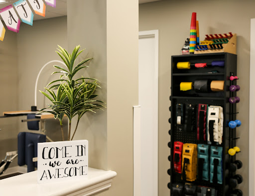 A vibrant and organized corner of a room featuring decorative elements and a welcoming sign.