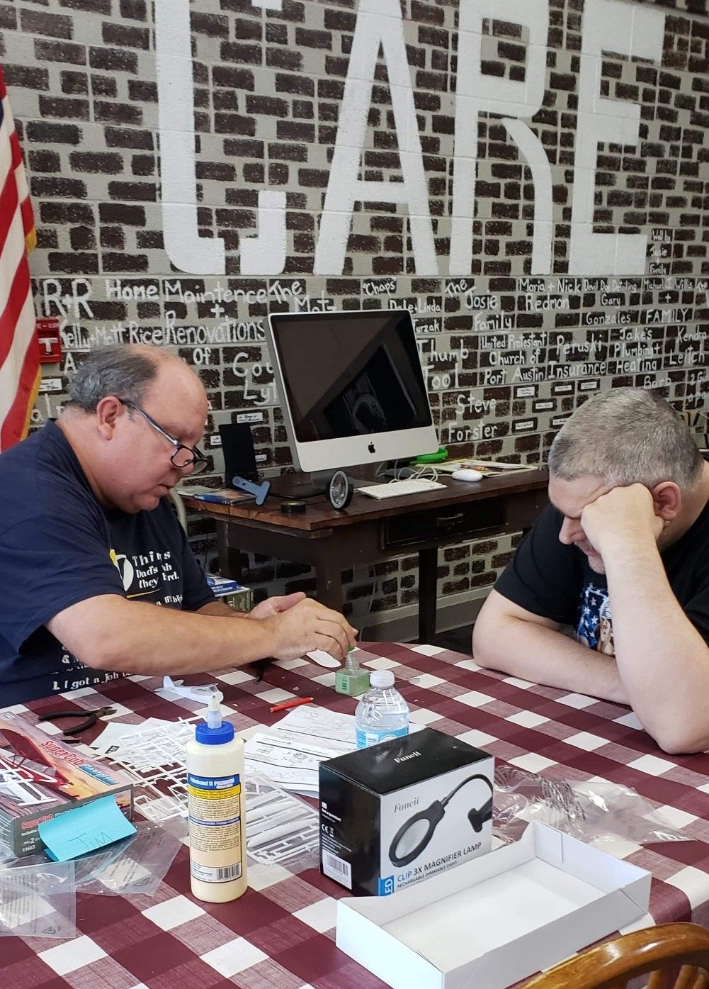 Two people engaged in a board game session at a table.