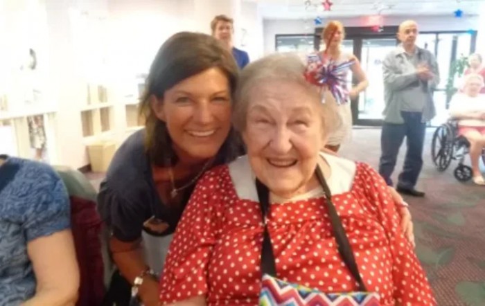 A joyful moment with two women smiling at a gathering.