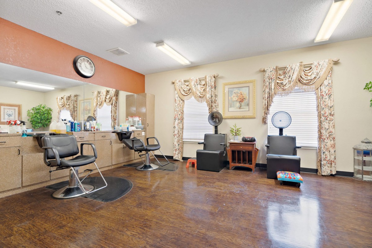 An interior view of a beauty salon with styling chairs and mirrors.