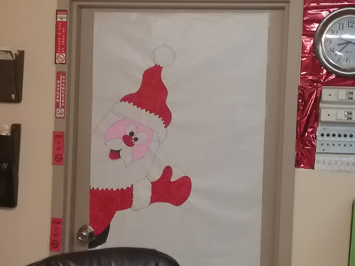 A cheerful holiday-themed door decoration featuring Santa Claus.